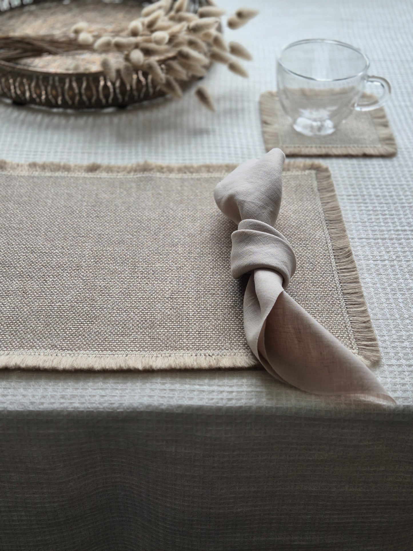 Aria natural stone pure linen textured placemat with hand brushed edges.