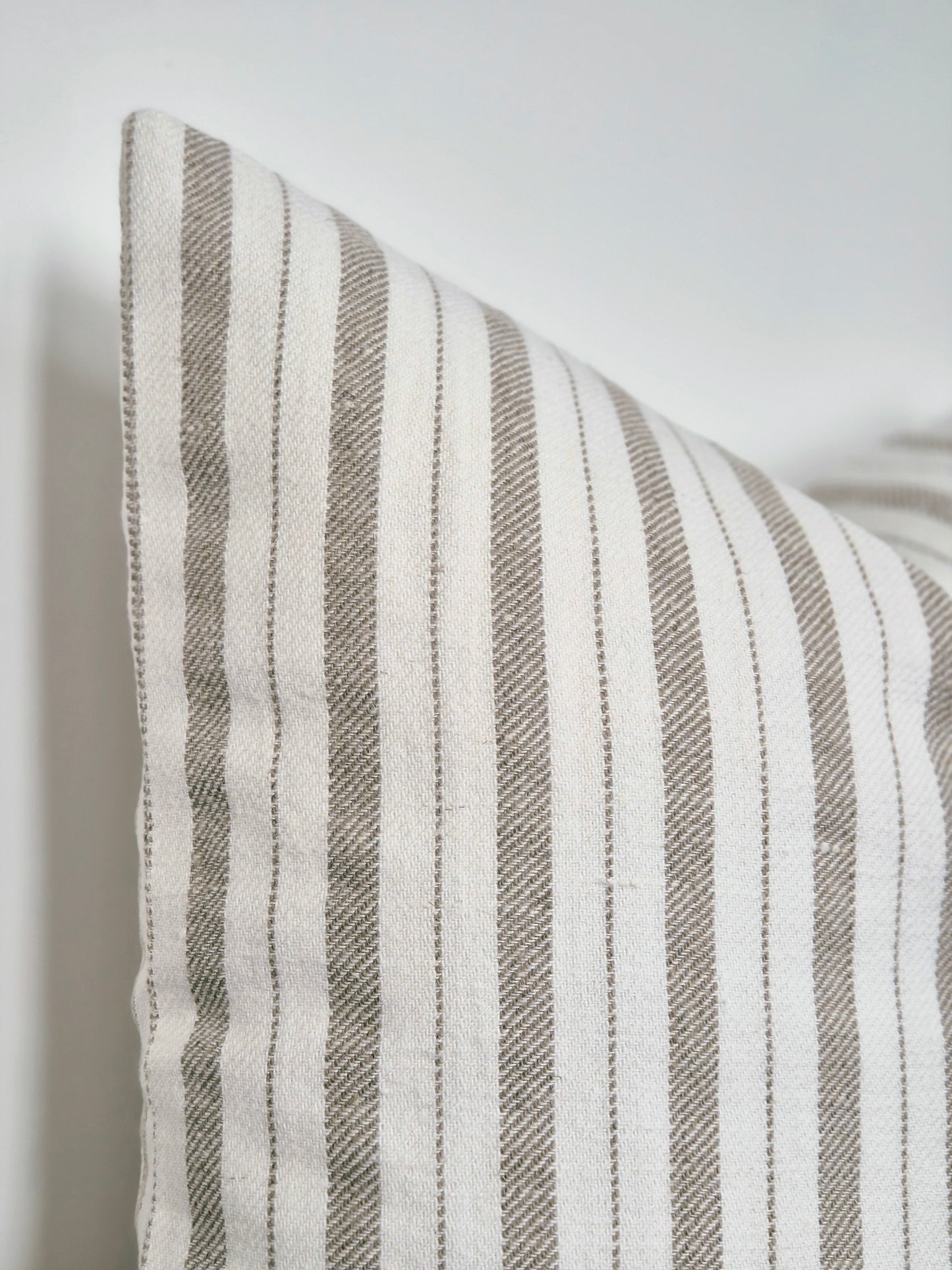 white and beige linen cushion