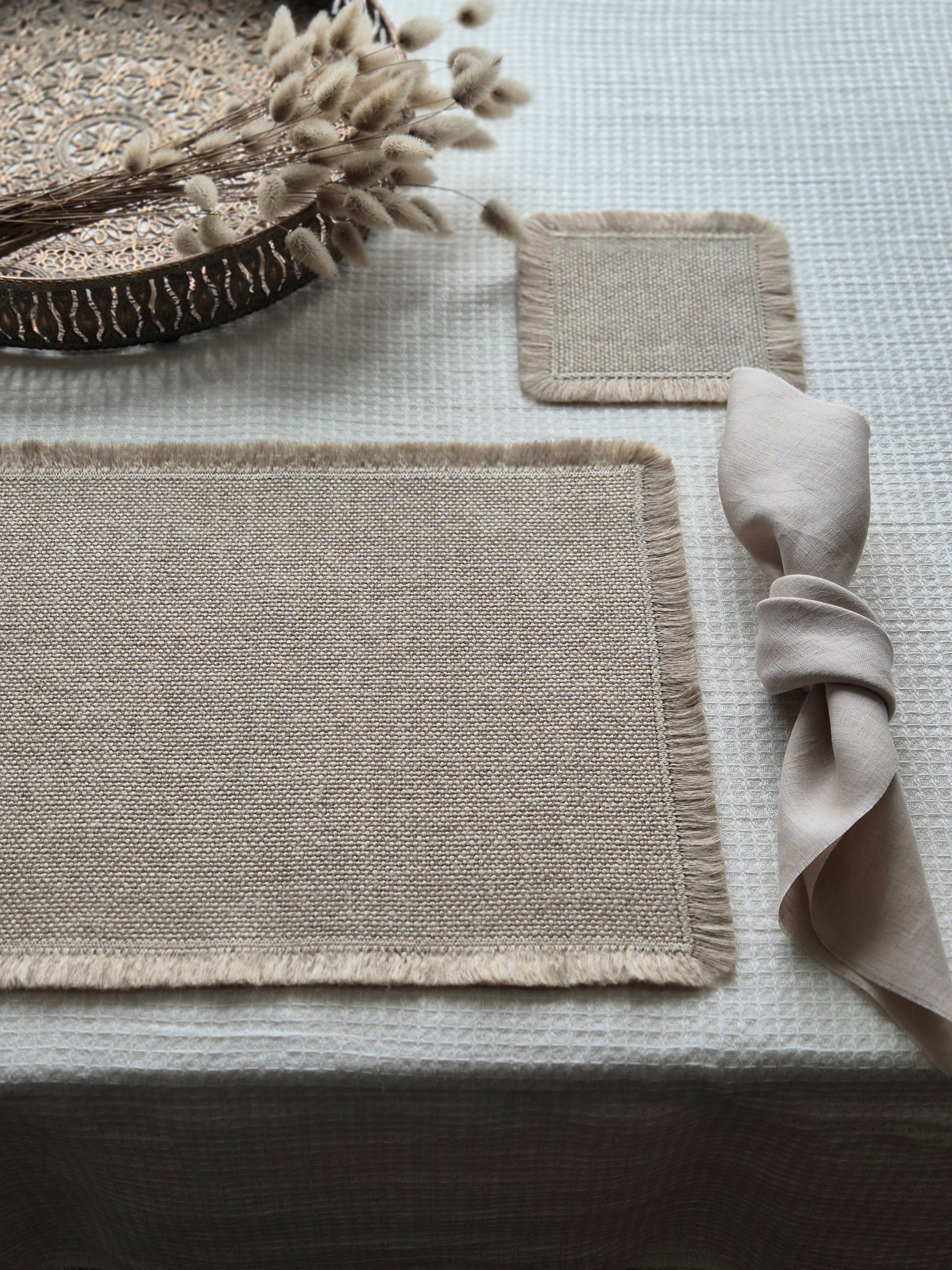 Aria natural stone pure linen textured placemat with hand brushed edges.
