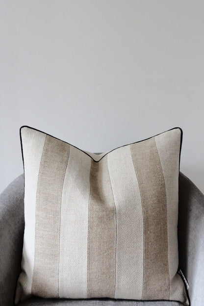 Pure flax linen cushion cover in classic rustic heavy weight linen in oatmeal beige and sand colour. Contrasting triple stripe design with modern black piping edge