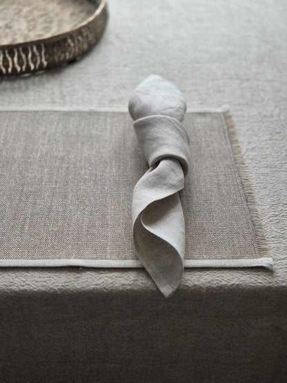 Natural stone linen placemat with hand brushed edges and contrasting oatmeal trim