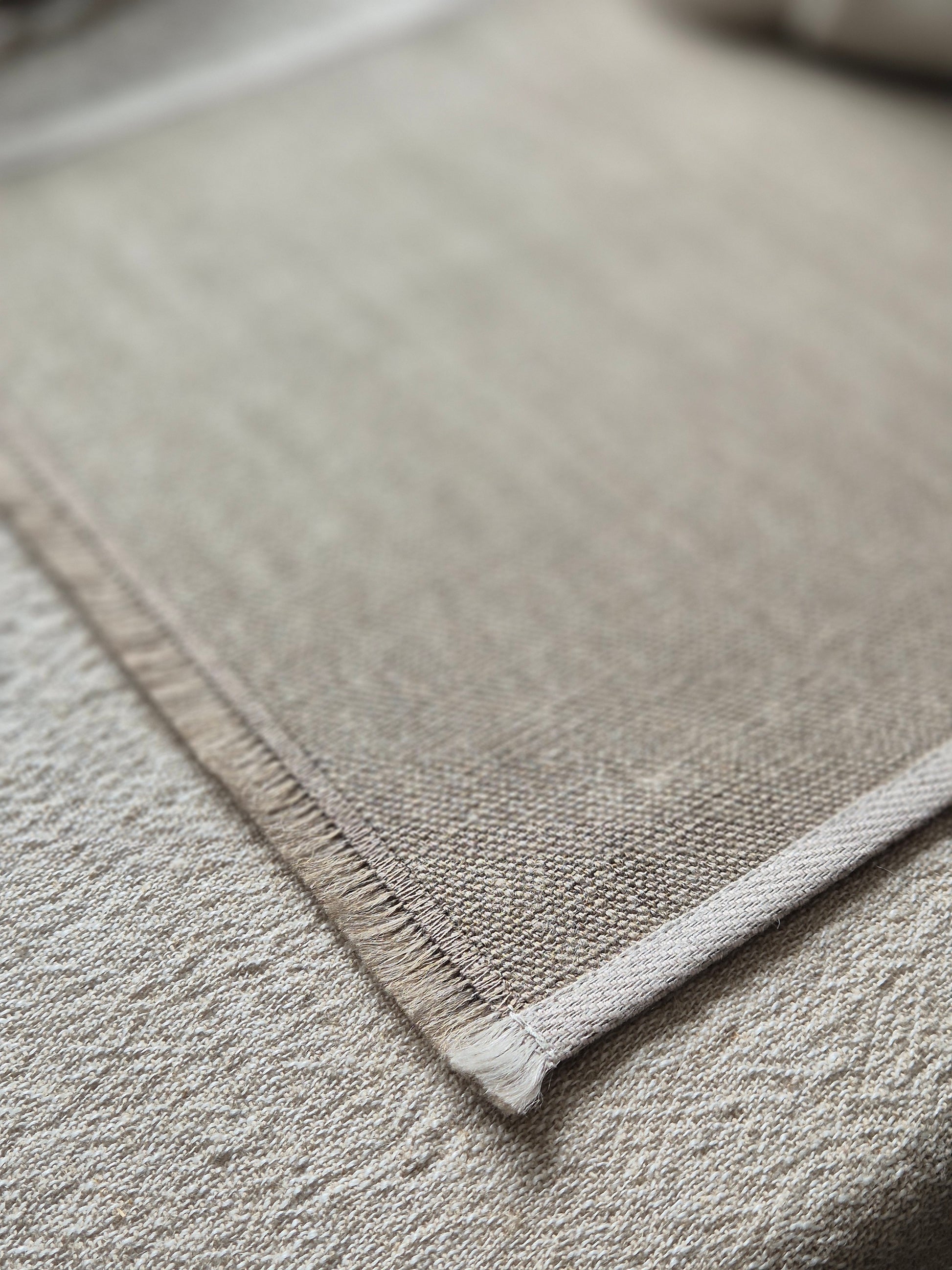 Natural stone linen placemat with hand brushed edges and contrasting oatmeal trim