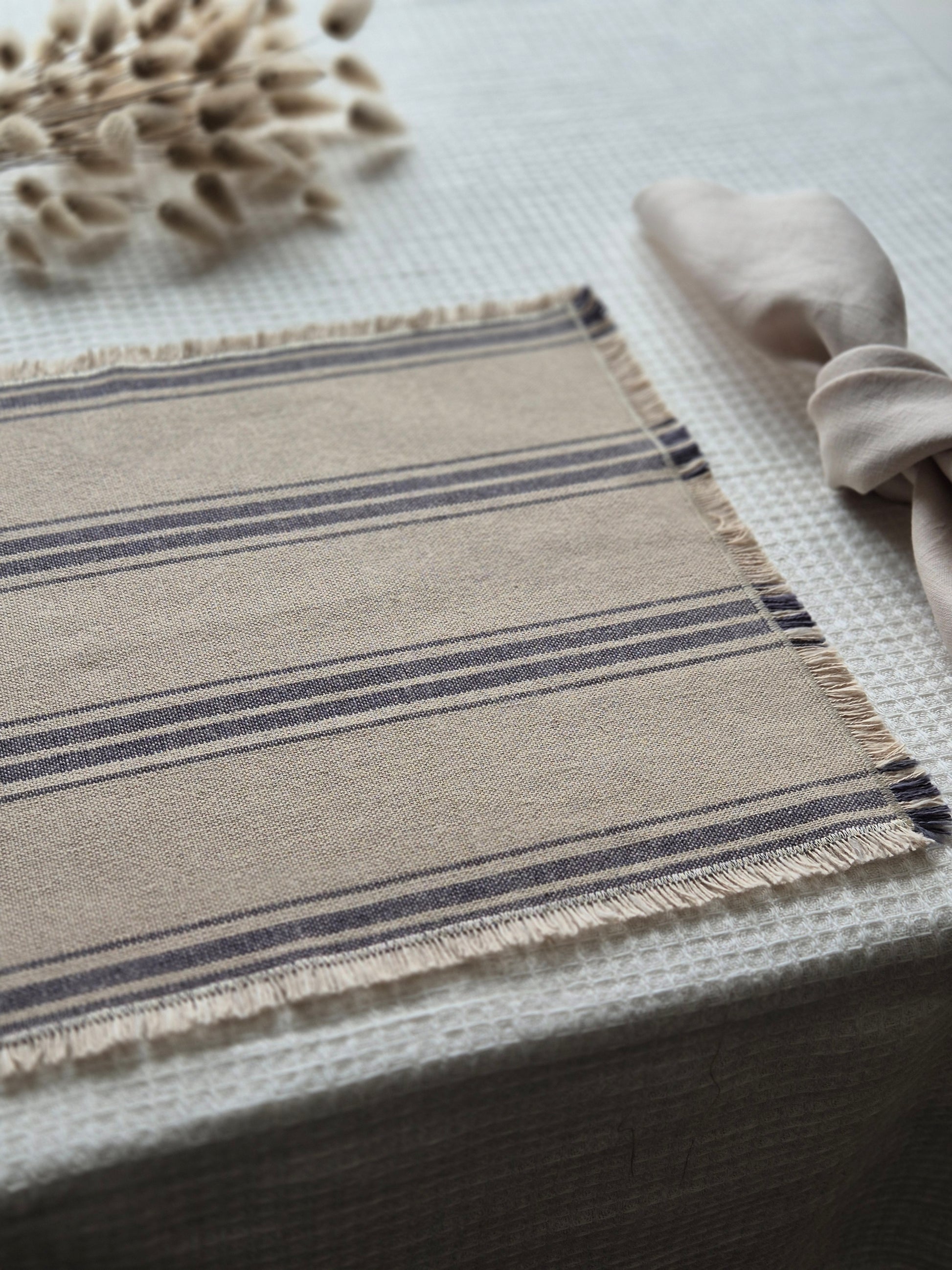 Striped linen placemat with frayed edges