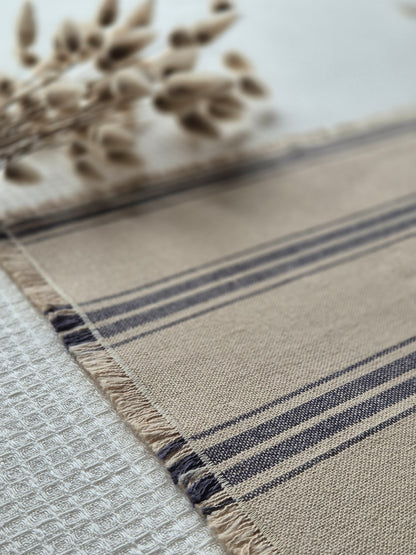 Striped linen placemat with frayed edges