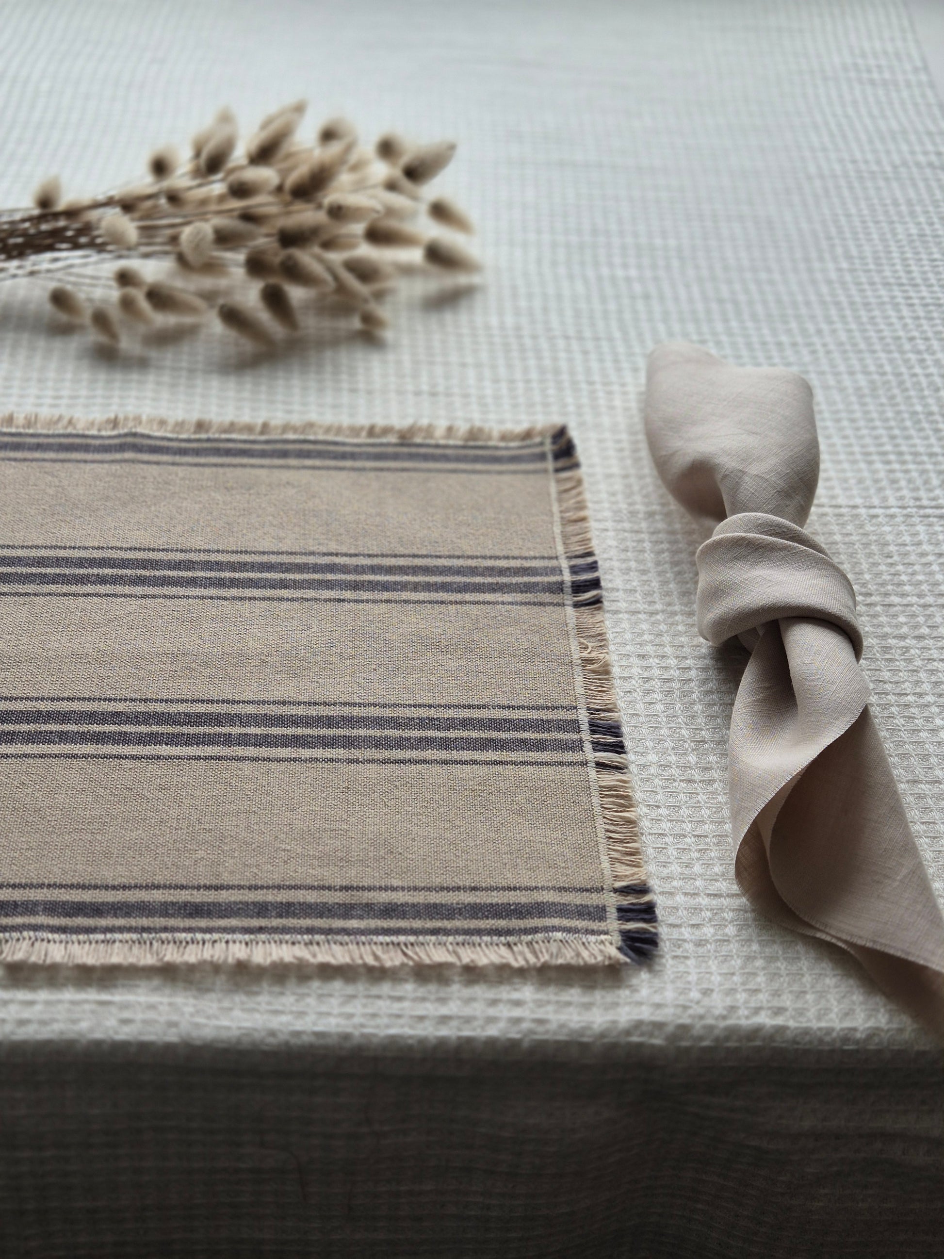 Striped linen placemat with frayed edges