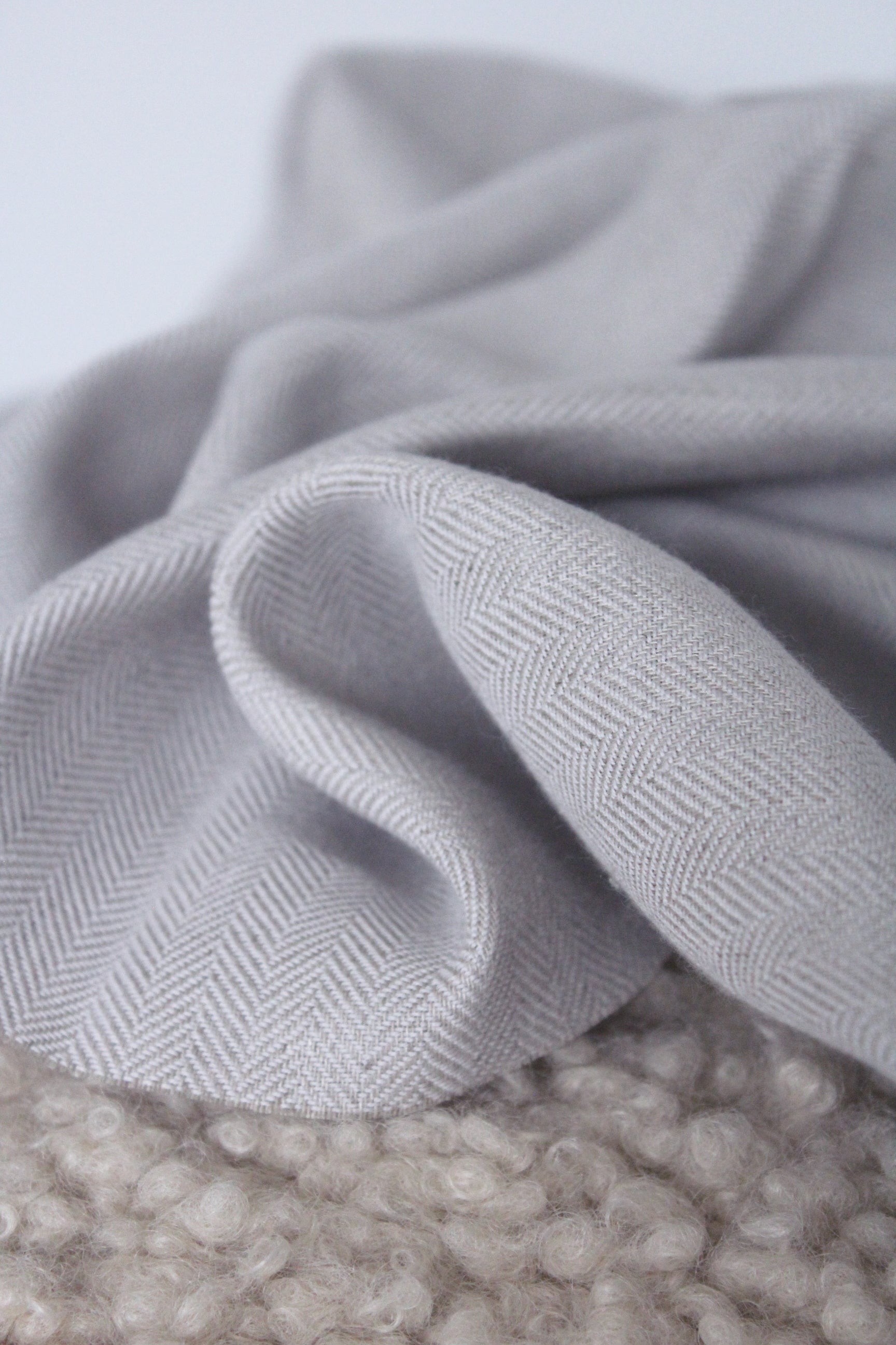 pure natural flax linen, warm grey with purple undertone, herringbone weave texture, medium weight fabric