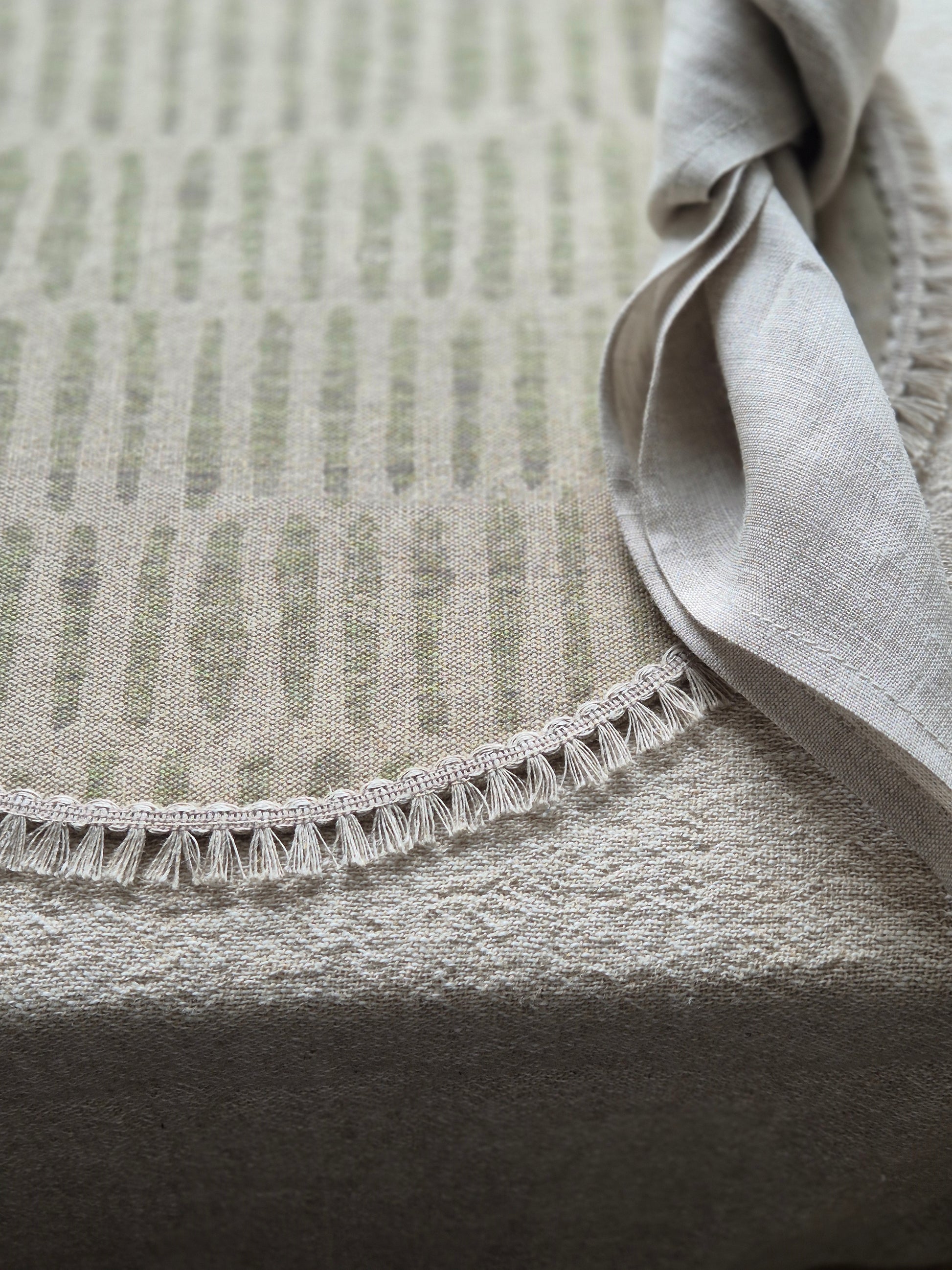 Mia round linen placemat in naturals tone and soft sage green colour with linen fringe trim