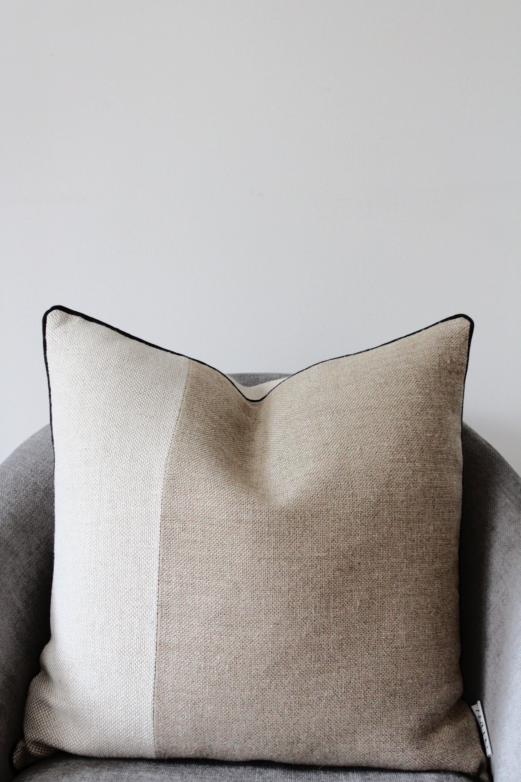 Pure flax linen cushion cover in classic rustic heavy weight linen in oatmeal beige and sand colour. Contrasting block stripe design with modern black piping edge
